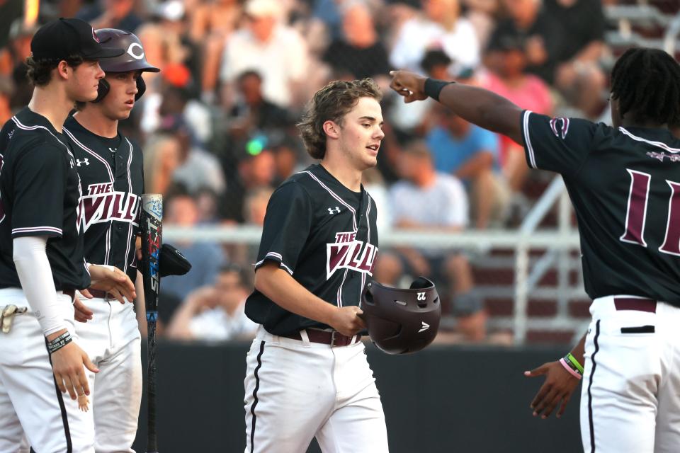 Collierville's Braden Sheals celebrates scoring a run with his teammates against Houston during their Region Final at Collierville High School on Wednesday, May 18, 2022.