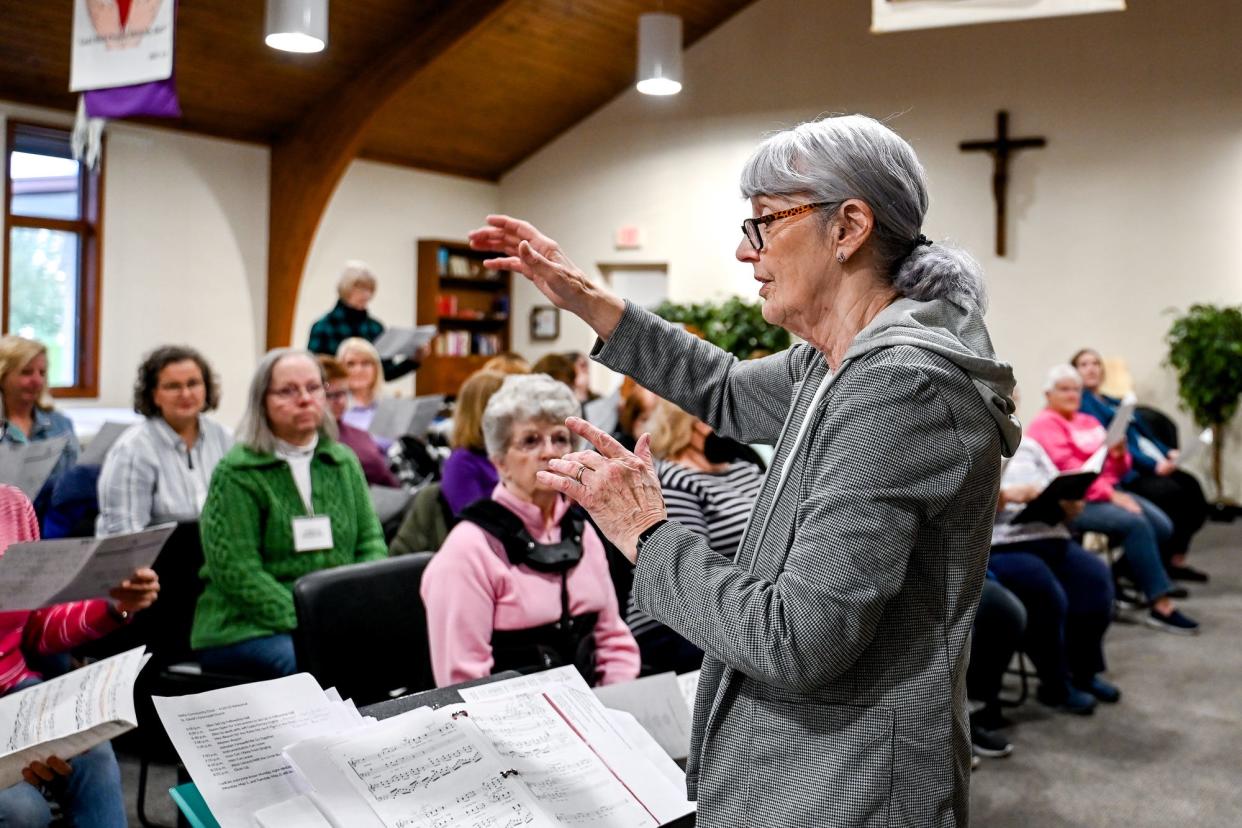 Delta Community Choir director Ellen McKenzie, right, leads a practice on Monday, April 24, 2023, at St. David's Episcopal Church in Lansing.