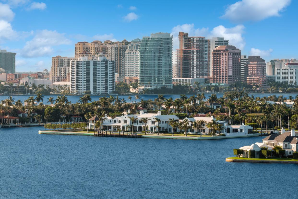 The West Palm Beach skyline rises behind Tarpon Island, center, Palm Beach's only private island.