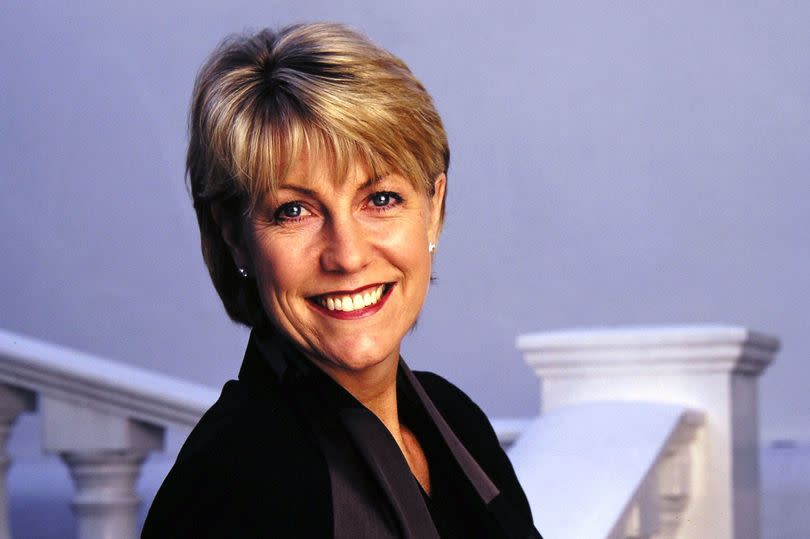 Jill Dando leaning on a bannister, smiling