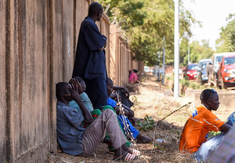 Relatives of victims of an attack on a road leading to the Boungou mine, operated by Canadian gold miner Semafo, wait outside a morgue in Ouagadougou