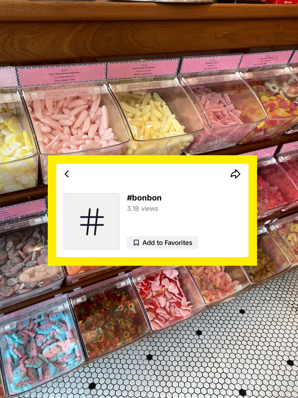 Assorted candy bins filled with various types of sweets, such as gummies, licorice, and marshmallows, at a candy shop