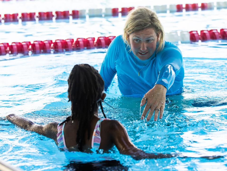 FAST Aquatics Program Director Gemma Fleming gives some pointers on the freestyle stroke to Mackenzie Speed, 11, before she swam to the wall during swim lesson on July 24 at FAST in Ocala.