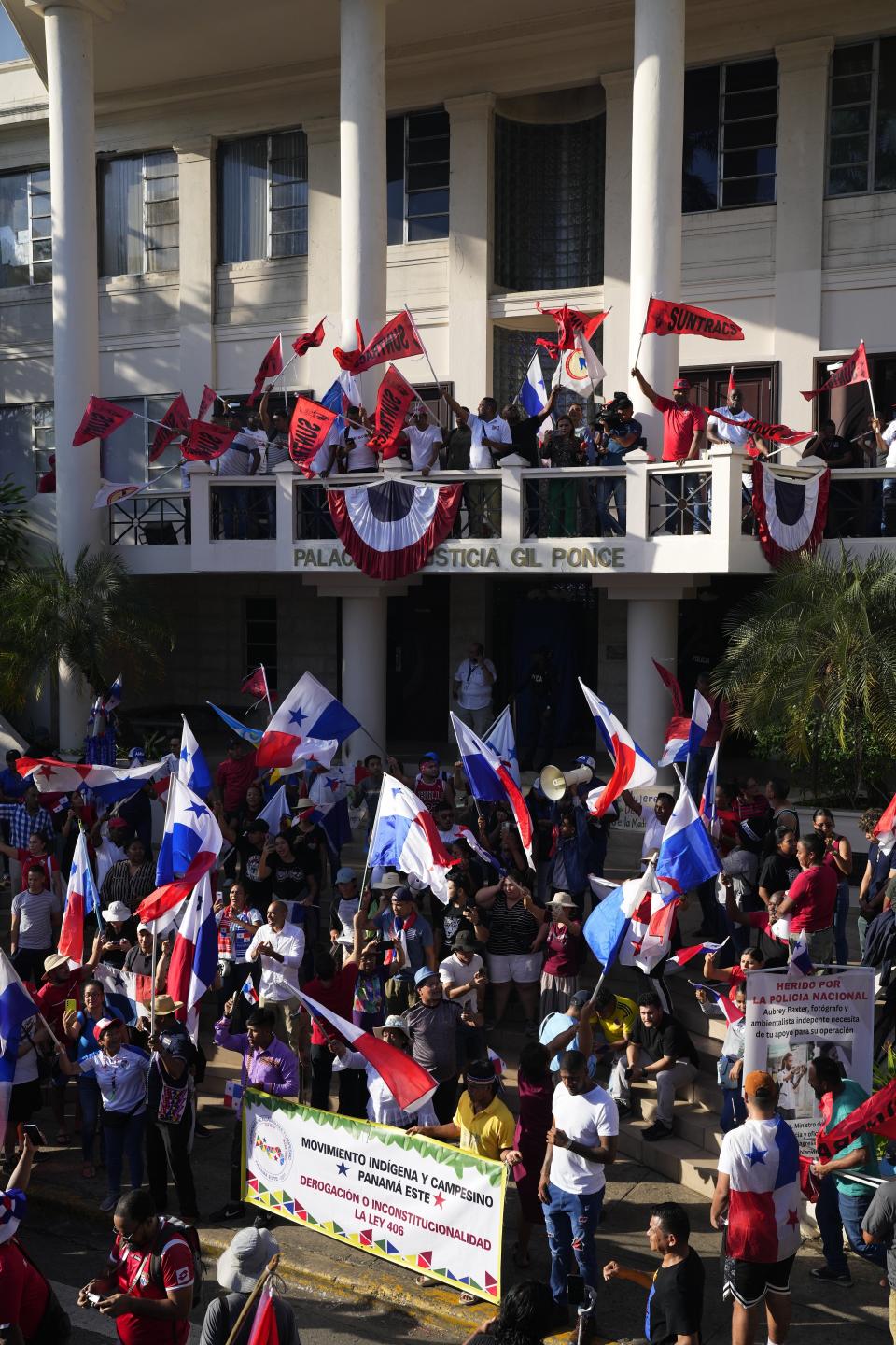 Protesters celebrate as they learn that Panama's Supreme Court has declared unconstitutional a 20-year concession for a Canadian copper mine that had sparked weeks of protests, in Panama City, Tuesday, Nov. 28, 2023. (AP Photo/Arnulfo Franco)