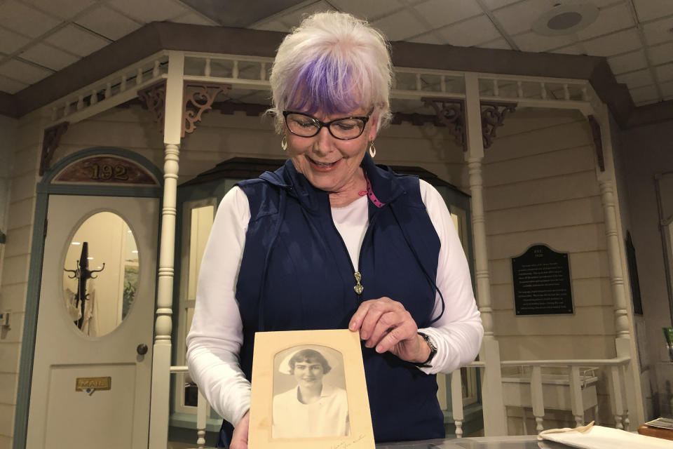 Nurse practitioner Sigrid Stokes, 76, holds a photograph of her mother at the Salinas Valley Memorial Hospital in Salinas, Calif., Wednesday, Feb. 3, 2021. Stokes is following in her family's footsteps during the pandemic. In 1918, Stokes' mother Kristine Berg Mueller was a 14-year-old hospital volunteer in Norway during the Spanish Flu pandemic, putting her in regular contact with the deadly disease. (AP Photo/Haven Daley)