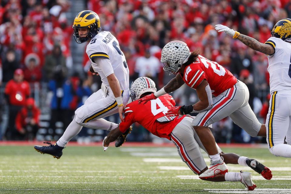 Michigan quarterback J.J. McCarthy (9) runs against Ohio State cornerback JK Johnson (4) during the second half Nov. 26, 2022 at Ohio Stadium in Columbus.