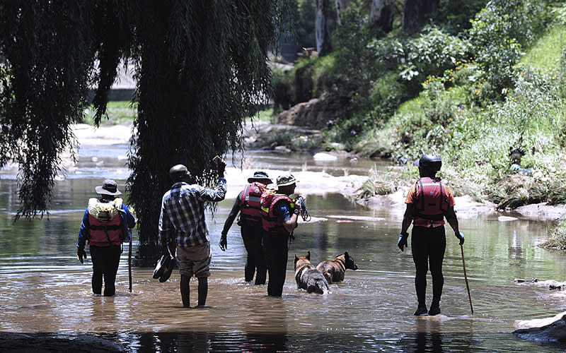 Rescue workers search the waters of the Jukskei river in Johannesburg, South Africa