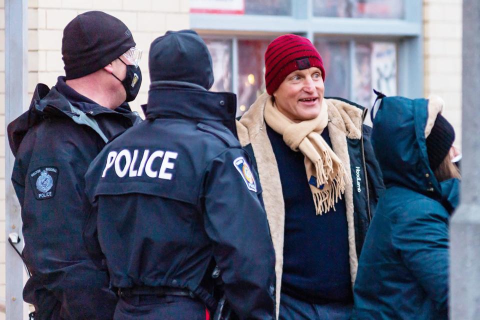 <p>Woody Harrelson talks to the crew and local police while on the set of <em>The Man From Toronto </em>on Monday in Toronto, Canada.</p>