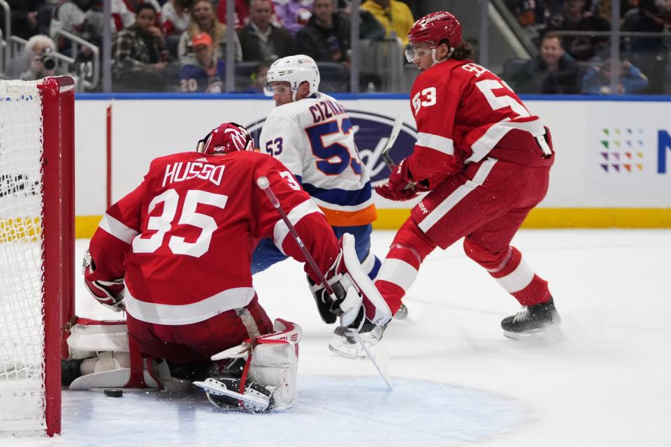 Detroit Red Wings' Moritz Seider watches as New York Islanders' Casey Cizikas (53) shoots the puck past goaltender Ville Husso for a goal during the second period of an NHL hockey game, Monday, Oct. 30, 2023, in Elmont, N.Y. (AP Photo/Frank Franklin II)