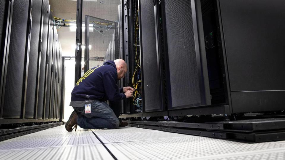 Anthony Banta, lead network engineer with ITS, installs new hardware at a secure server facility operated by the Idaho State Controller’s Office.