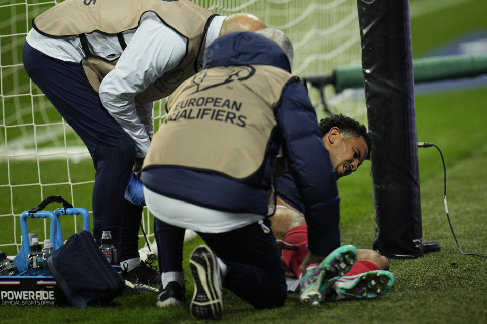 Injured France's Warren Zaire-Emery is provided assistance during the Euro 2024 group B qualifying soccer match between France and Gibraltar in Nice, France, Saturday, Nov. 18, 2023. (AP Photo/Daniel Cole)