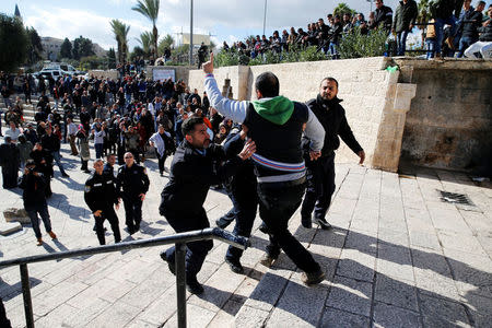 Israeli policemen scuffle with a Palestinian man during a protest following U.S. President Donald Trump's announcement that he has recognized Jerusalem as Israel's capital, near Damascus Gate in Jerusalem's Old City December 7, 2017. REUTERS/Ammar Awad