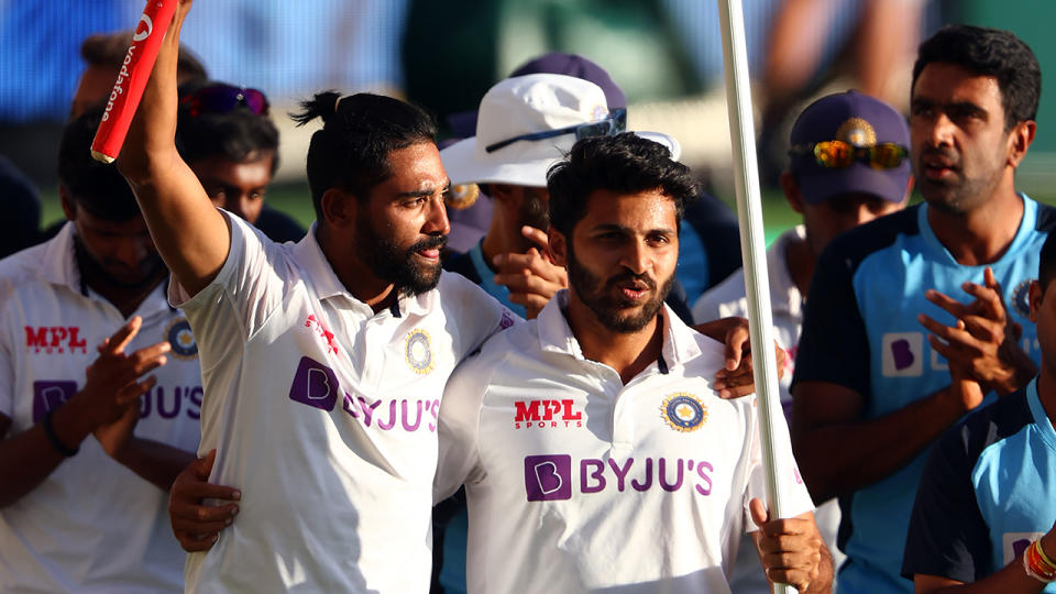 India's pacemen Mohammed Siraj and Shardul Thakur celebrate the victory in the fourth cricket Test match against Australia at The Gabba in Brisbane on January 19, 2021. (Photo by PATRICK HAMILTON/AFP via Getty Images)