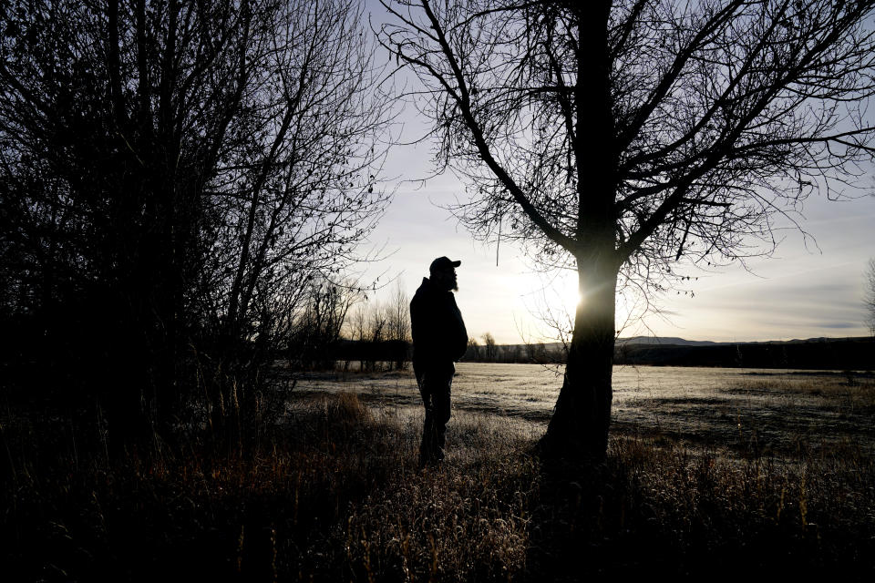 Ron Geary, an electrician at Craig Station, stands near the Yampa River on Thursday, Nov. 18, 2021, in Craig, Colo. Craig, a small town in northwest Colorado is losing its coal plant and residents fear it is the beginning of the end for their community. One of Geary's fears during this transition is the mental health of his colleagues who are losing a part of their identity and job security with retirement plan. (AP Photo/Rick Bowmer)