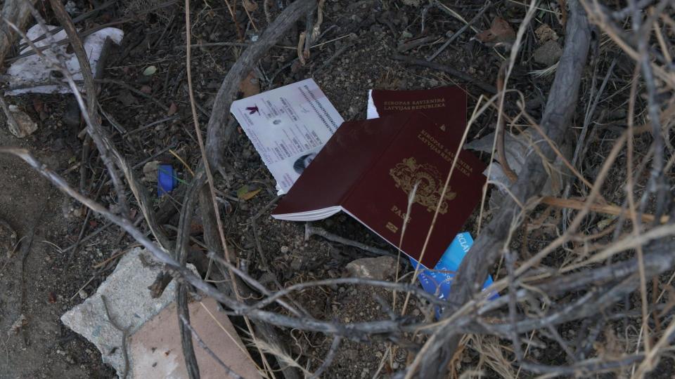Travel documents from around the world have been left on the ground at the border gap. / Credit: 60 Minutes