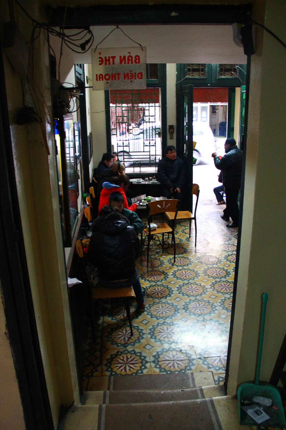 In this photo taken Jan. 5, 2013, customers drink coffee at Cafe Tho in downtown Hanoi, Vietnam. Starbucks announced Thursday, Jan. 3, 2013, it would enter Vietnam in early February with a cafe in Ho Chi Minh City. But the Seattle-based company faces a unique market in Vietnam, where French-inspired coffee culture reigns supreme; two homegrown chains have established presences; and family-run sidewalk cafes are as ubiquitous as noodle shops. (AP Photo/Mike Ives)