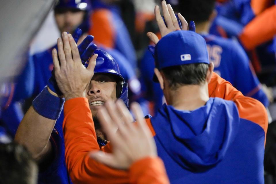 New York Mets' Francisco Alvarez, left, celebrates in the dugout after hitting a grand slam during the third inning of the second game of a baseball doubleheader against the Philadelphia Phillies, Saturday, Sept. 30, 2023, in New York. (AP Photo/Mary Altaffer)