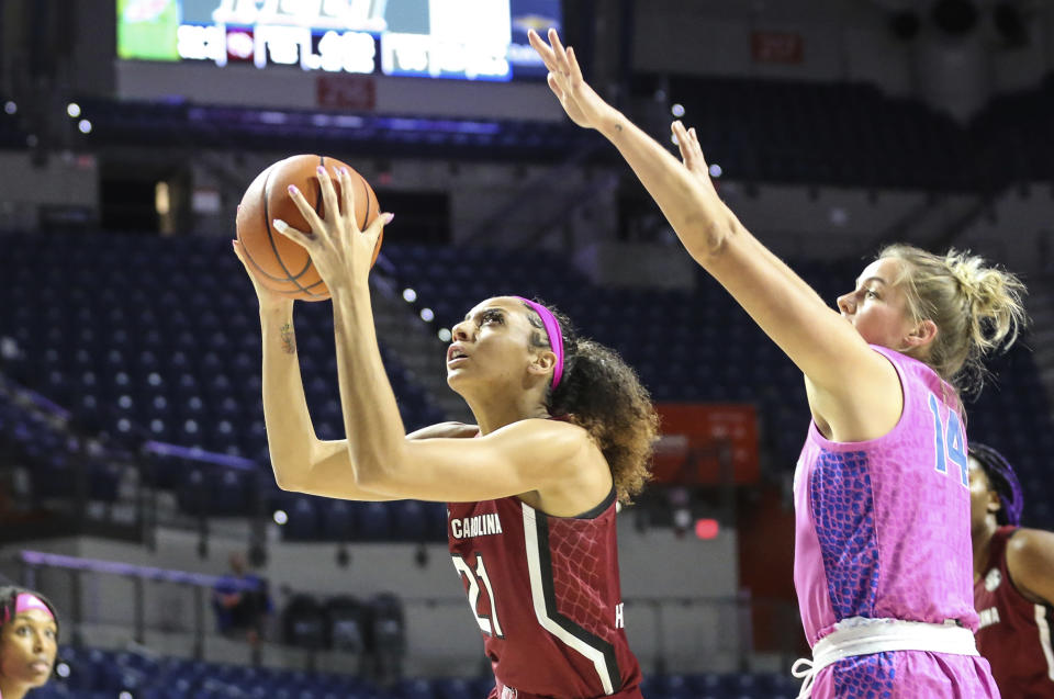 South Carolina forward Mikiah Herbert Harrigan (21) shoots while defended by Florida guard Kristina Moore (14) during the first half of an NCAA college basketball game Thursday, Feb. 27, 2020, in Gainesville, Fla. (AP Photo/Gary McCullough)