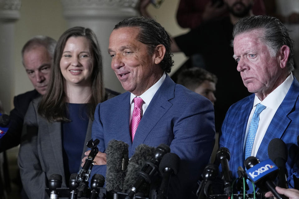 Defense attorney Tony Buzbee, center, with attorney Dan Cogdell, right, talks to the media after Texas Attorney General Ken Paxton was acquitted in his impeachment at the Texas Capitol, Saturday, Sept. 16, 2023, in Austin, Texas. (AP Photo/Eric Gay)