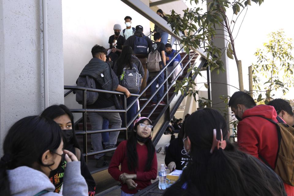 Lynwood High School students walk on an outdoor staircase.
