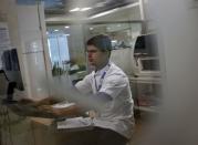 A lab technician works at the Fortis Memorial Hospital at Gurgaon on the outskirts of New Delhi, India, May 20, 2015. REUTERS/Anindito Mukherjee