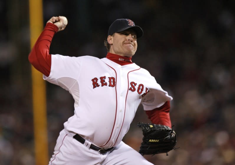 FILE - In this Oct. 25, 2007, file photo, Boston Red Sox's Curt Schilling pitches against the Colorado Rockies in Game 2 of the baseball World Series at Fenway Park in Boston. Like many baseball writers, C. Trent Rosecrans viewed the Hall of Fame vote as a labor of love. The results of the 2021 vote will be announced Tuesday, Jan. 26, 2021, and Rosecrans was not alone in finding the task particularly agonizing this time around. With Schilling's candidacy now front and center — and Barry Bonds and Roger Clemens still on the ballot as well — voters have had to consider how much a player's off-field behavior should affect his Hall of Fame chances. (AP Photo/Kathy Willens, File)