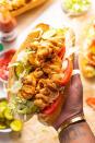 <p>Crispy buttermilk chicken meets the tangy mayo-based sauce, remoulade, in this classic NOLA-style hoagie. Make sure to have it “dressed” — i.e., piled with lettuce, tomatoes, pickles and sauce. </p><p>Get the <strong><a href="https://www.butterbeready.com/chicken-po-boys-with-remoulade-sauce/" rel="nofollow noopener" target="_blank" data-ylk="slk:Chicken Po’ Boys with Remoulade Sauce recipe;elm:context_link;itc:0;sec:content-canvas" class="link ">Chicken Po’ Boys with Remoulade Sauce recipe</a></strong> from Butter Be Ready. </p>