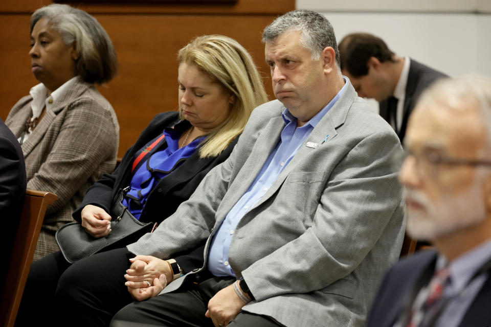 Tony and Jennifer Montalto hold hands during closing arguments in the trial of former Marjory Stoneman Douglas High School School Resource Officer Scot Peterson , Monday, June 26, 2023, at the Broward County Courthouse in Fort Lauderdale, Fla. Peterson is accused of failing to confront the shooter who murdered 14 students and three staff members at a Parkland high school five years ago. The Montalto's daughter, Gina, was killed in the 2018 shootings. (Amy Beth Bennett/South Florida Sun-Sentinel via AP, Pool)