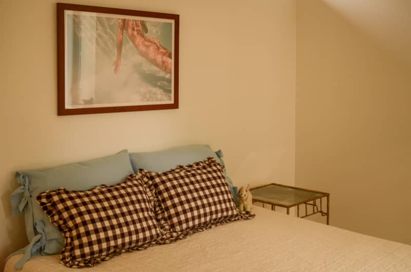 Pillows on bed of neutral bedroom.