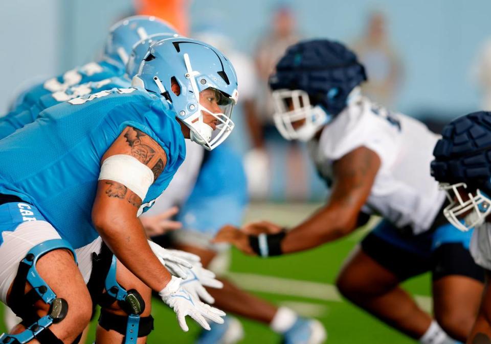 North Carolina offensive lineman Zach Rice lines up during a drill at UNC’s first football practice of the season on Friday, July 29, 2022, in Chapel Hill, N.C.