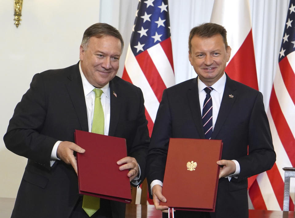 US Secretary of State Mike Pompeo, left, and Poland's Minister of Defence Mariusz Blaszczak pose for the media after signing the US-Poland Enhanced Defence Cooperation Agreement in the Presidential Palace in Warsaw, Poland, Saturday Aug. 15, 2020. Pompeo is on a five day visit to central Europe. (Janek Skarzynski/Pool via AP)