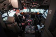 A Boeing 737 Max airplane captain poses for a photo in a maintenance hanger in Tulsa