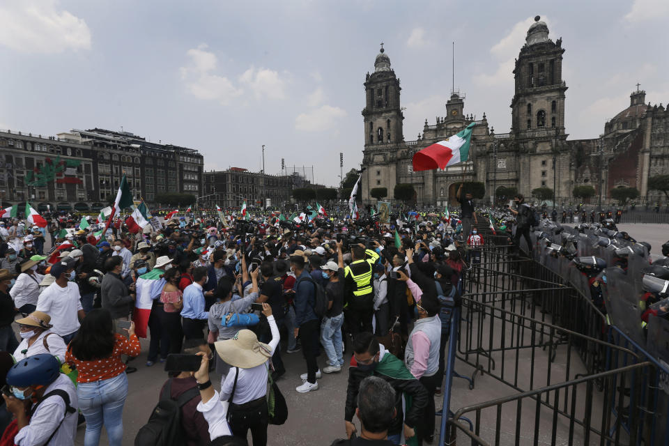 Police in riot gear block demonstrators who are demanding the resignation of Mexican President Andrés Manuel López Obrador, commonly known by his initials AMLO, from entering Mexico City's main square the Zocalo, Wednesday, Sept. 23, 2020. (AP Photo/Marco Ugarte)