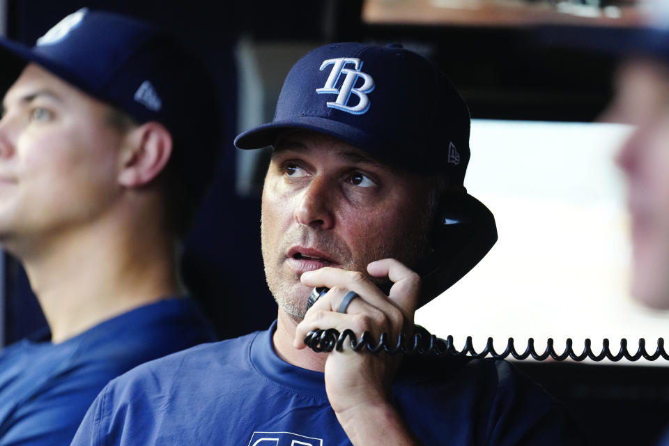 Tampa Bay Rays manager Kevin Cash makes a call to the bullpen in the fourth inning of a baseball game against the Atlanta Braves Friday, June 14, 2024, in Atlanta. (AP Photo/John Bazemore)