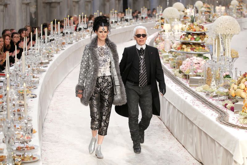 FILE PHOTO: British model Stella Tennant walks with designer Karl Lagerfeld during the Metiers D'Art Show for Chanel fashion house in Paris