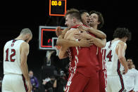 Wisconsin forward Carter Gilmore, back, guard Johnny Davis, middle, and forward Tyler Wahl celebrate after defeating St. Mary's 61-55 during an NCAA college basketball game at the Maui Invitational in Las Vegas, Wednesday, Nov. 24, 2021. (AP Photo/Rick Scuteri)