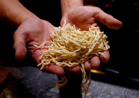Kenji Saito shows raw noodles at his ramen noodle shop in Tokyo, Japan April 12, 2019. REUTERS/Kim Kyung-hoon