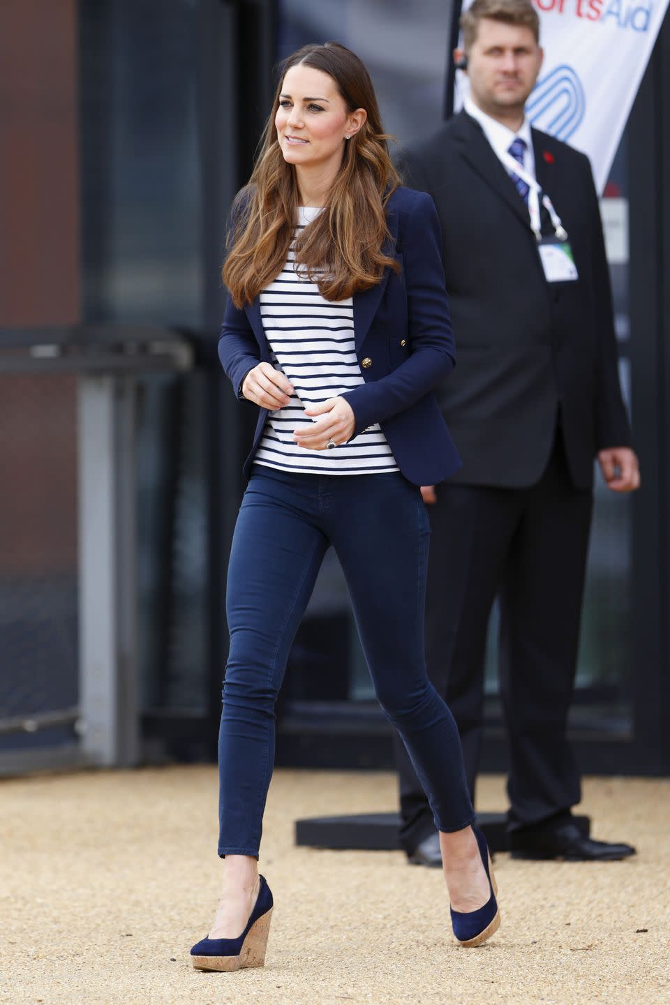 <p><em>October 18, 2013 —</em> Kate attended a SportsAid Athlete Workshop in London in skinny jeans, a Breton-striped shirt, a navy blazer, and her go-to wedge heels.</p>