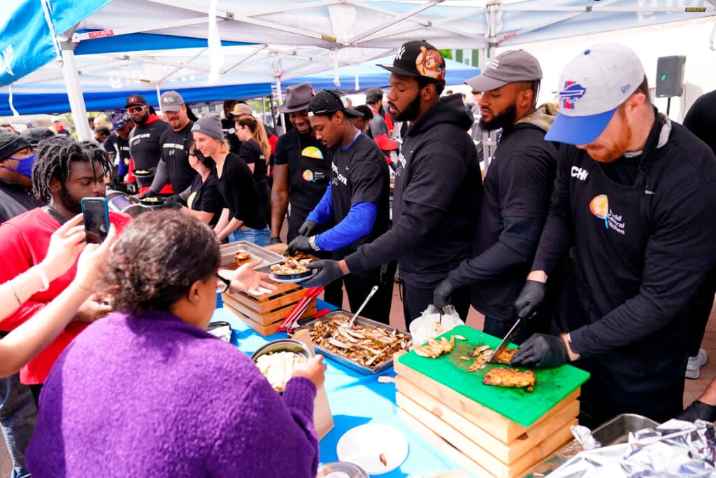 Buffalo Bills players serve food at a World Central Kitchen tent near the scene of Saturday’s shooting at a supermarket, in Buffalo, N.Y., Wednesday, May 18, 2022. (AP Photo/Matt Rourke)