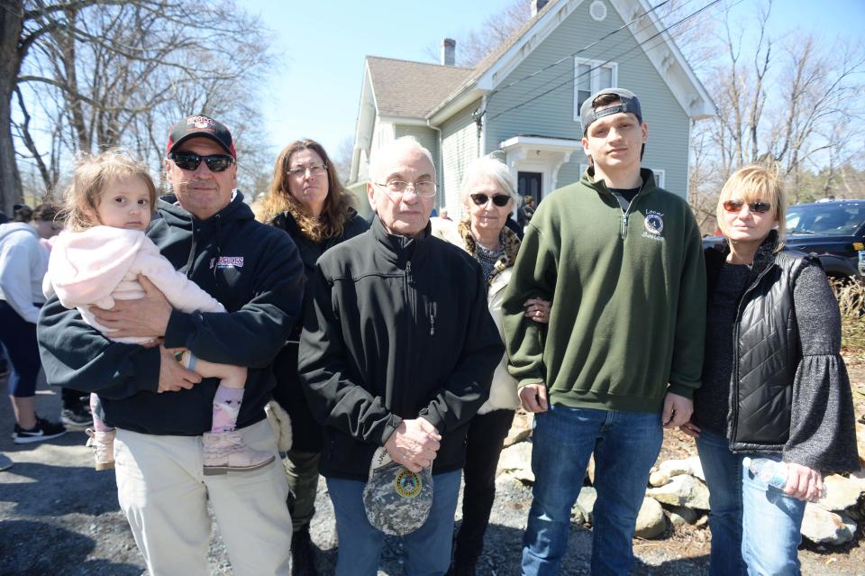 From left, Francisca Monsini, 3; Harold Monsini, brother; Cherie Monsini, sister; Harold Monsini Sr., father; Brenda Monsini, mother; Anthony Monsini, son; and Gina Monsini, sister; during a truck convoy that honored the life of family member Peter Monsini, 51, of Easton, on Saturday, April 2, 2022. Peter Monsini was killed in a construction accident when a parking garage collapsed at 1 Congress St. in Boston on March 26.