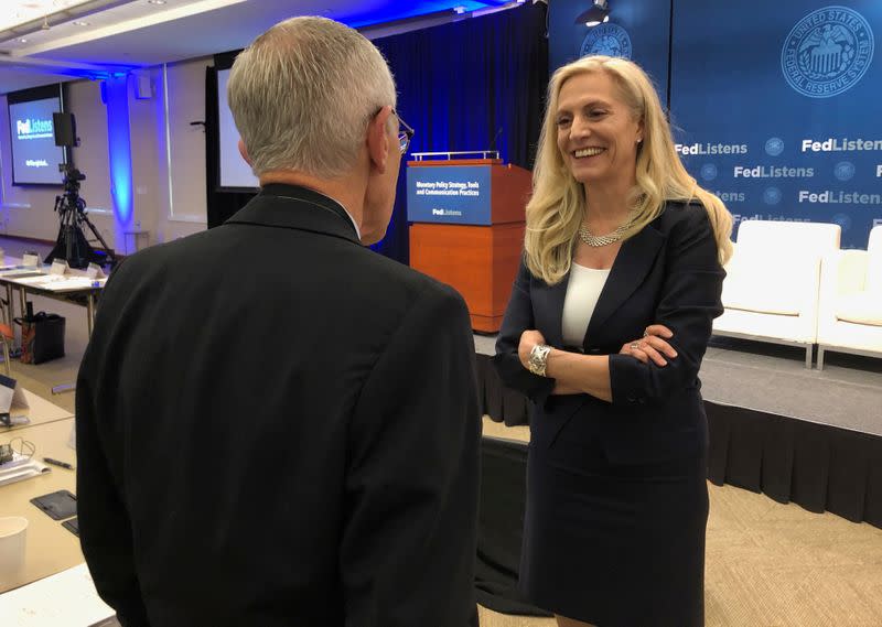 FILE PHOTO: Federal Reserve Governor Lael Brainard speaks with former Fed Vice Chair Stanley Fischer at the Federal Reserve Bank of Chicago in Chicago