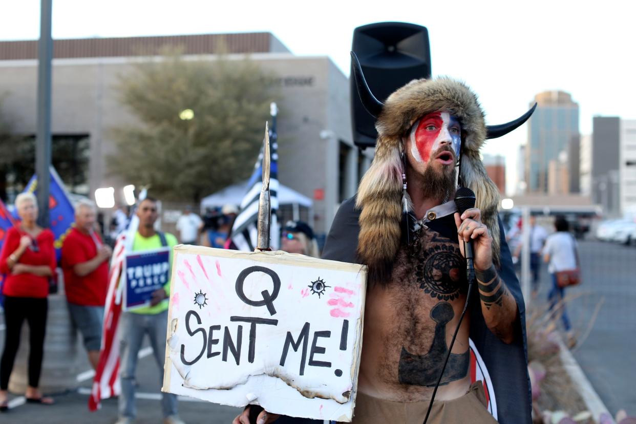 Jacob Anthony Chansley, who also goes by the name Jake Angeli, a QAnon believer speaks to a crowd of President Donald Trump supporters outside of the Maricopa County Recorder's Office where votes in the general election are being counted. 