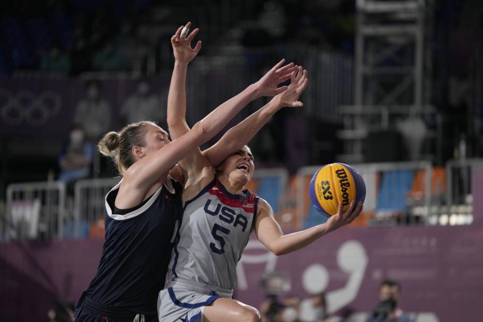 Kelsey Plum of the U.S. fights her way past Anastasiia Logunova of the Russian Olympic Committee team.