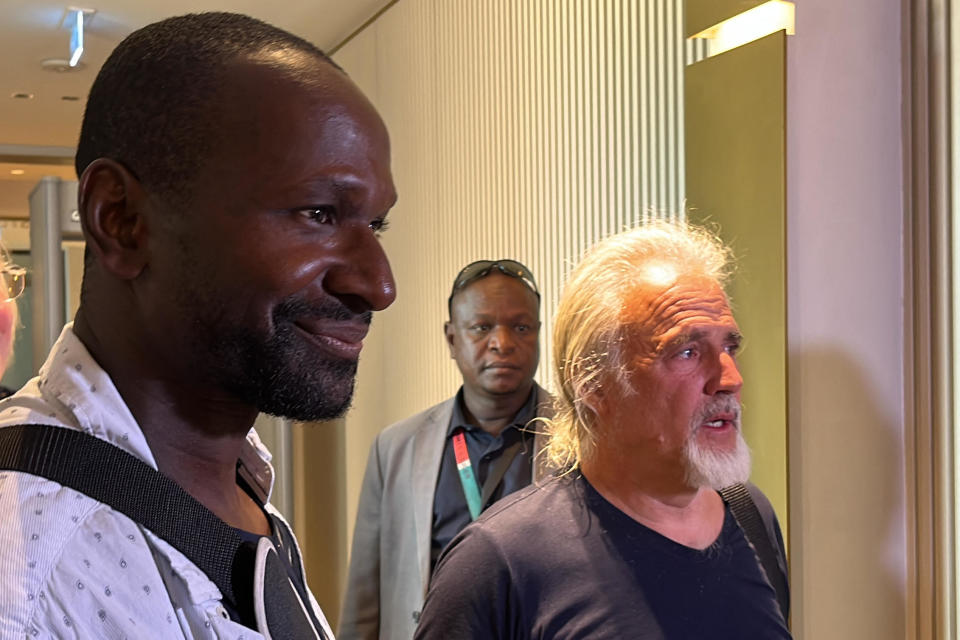 French journalist Olivier Dubois, left, freed nearly two years after he was kidnapped in Mali, and U.S. national Jeffery Woodke, right, freed after being kidnapped in October 2016 in Niger, are seen as they arrive at the Diori Hamani International Airport in Niamey on March 20, 2023. / Credit: SOULEYMANE AG ANARA/AFP via Getty Images