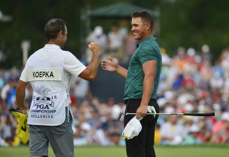 Aug 12, 2018; Saint Louis, MO, USA; Brooks Koepka celebrates with caddie Ricky Elliott after winning the PGA Championship golf tournament at Bellerive Country Club. Jeff Curry-USA TODAY Sports