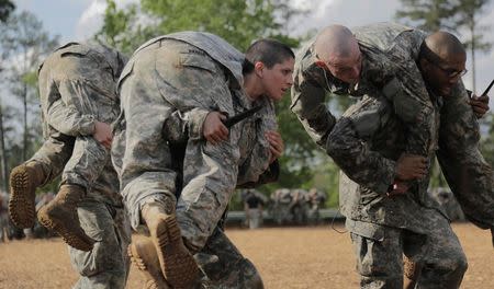 Then U.S. Army First Lieutenant Kirsten Griest (C) and fellow soldiers participate in combatives training during the Ranger Course on Fort Benning, Georgia, in this handout photograph taken on April 20, 2015 and obtained on August 20, 2015. REUTERS/Spc. Nikayla Shodeen/U.S. Army/Handout