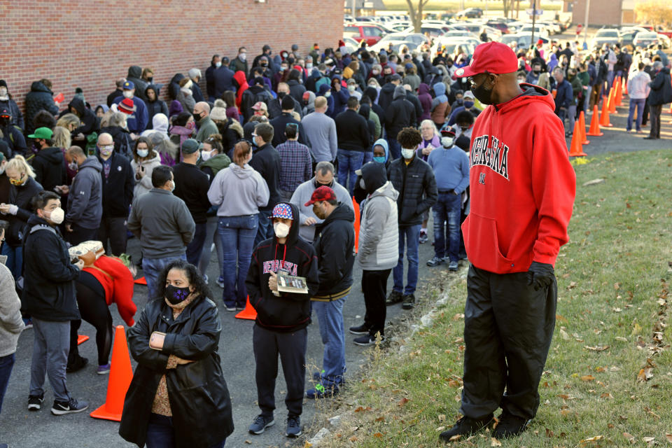 FILE - In this Saturday, Oct. 31, 2020 file photo, hundreds wait in lines to vote early at the Douglas County Election Commission office in Omaha, Neb. (AP Photo/Nati Harnik)