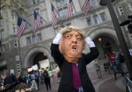 <p>An actor portraying US President Donald J. Trump calls on the President to release his tax returns outside the Trump Hotel in Washington, DC, USA, 15 April 2017. (Photo: Jim Lo Scalzo/EPA) </p>