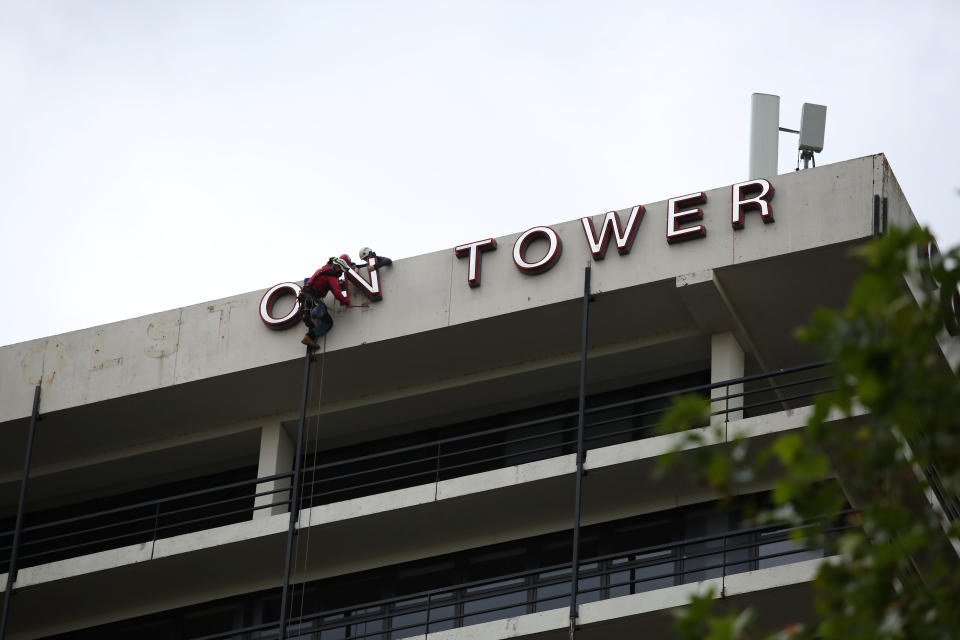 Workmen take down the lettering on Colston Tower. (Tom Wren/SWNS)