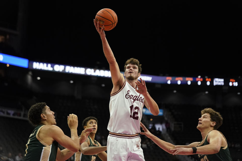 Boston College forward Quinten Post (12) puts up a shot during the first half of an NCAA college basketball game against Colorado State Wednesday, Nov. 22, 2023, in Kansas City, Mo. (AP Photo/Charlie Riedel)